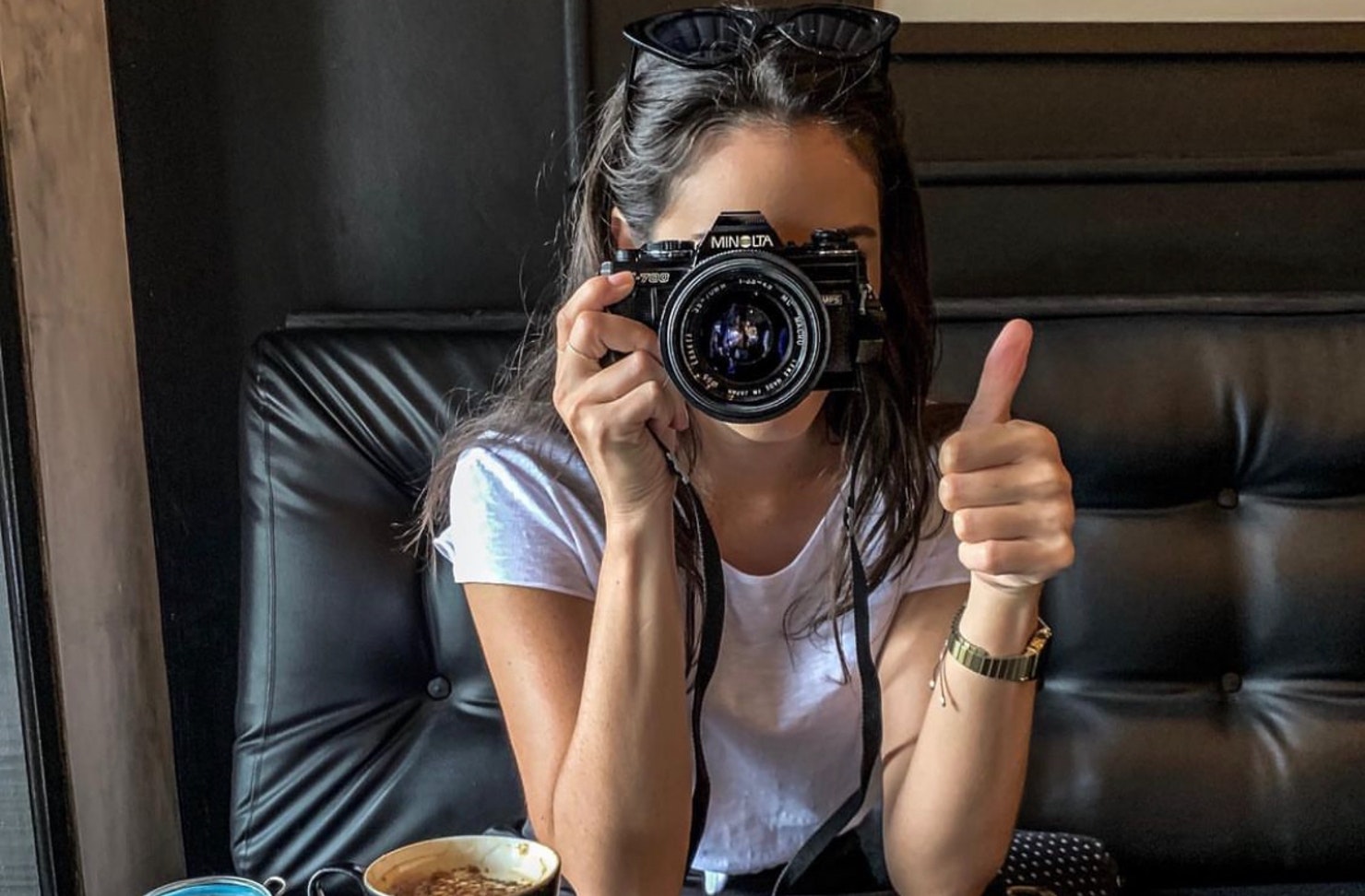 Woman holding camera taking a photo