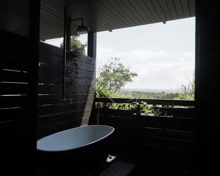The open air bath with sleek wooden walls at Shack Palace Noosa Home Sunshine Coast