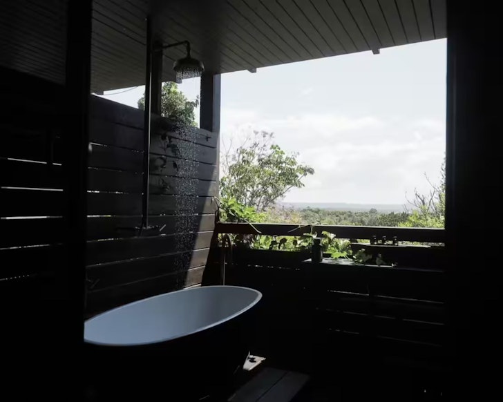 The open air bath with sleek wooden walls at Shack Palace Noosa Home Sunshine Coast
