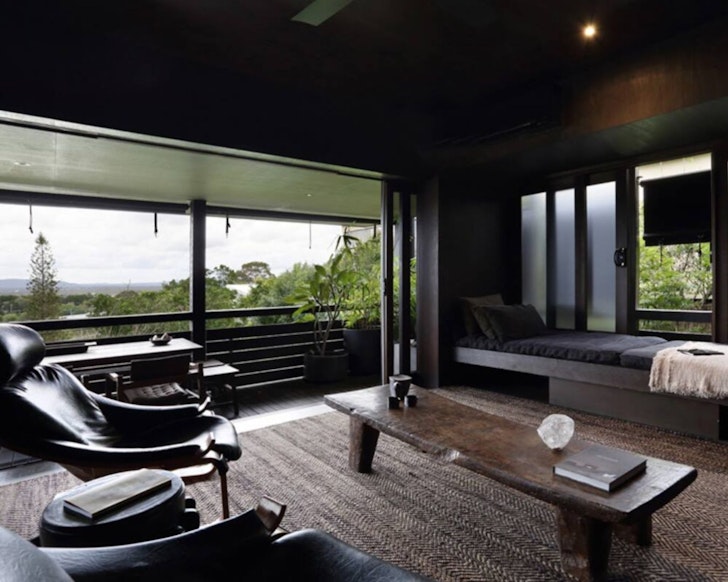 A view of the lounge with wooden walls and view at Shack Palace Noosa Home one of the best Noosa Airbnbs