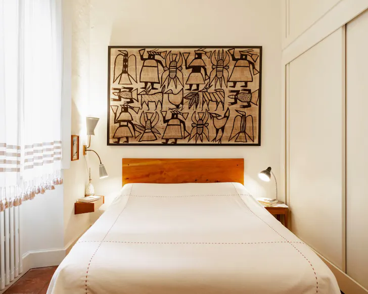 The bedroom with art at Shades of Clay best Milan Airbnbs