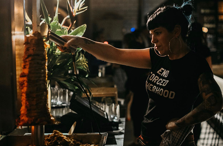 Shannon Martinez shaving off kebab meat.