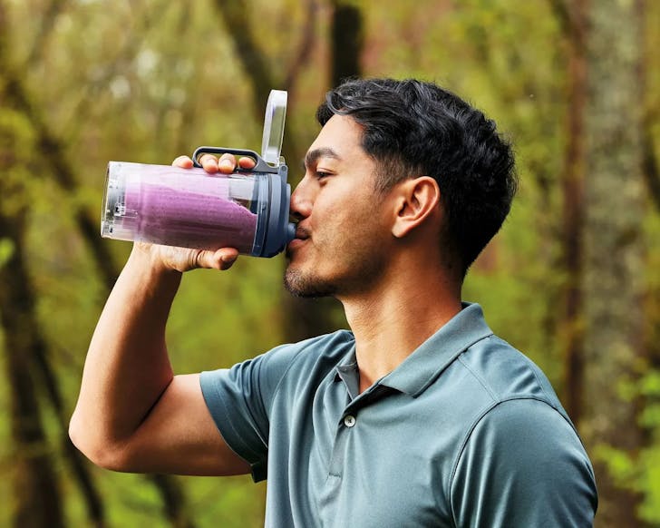 A man sips a smoothie from a SharkNinja blender