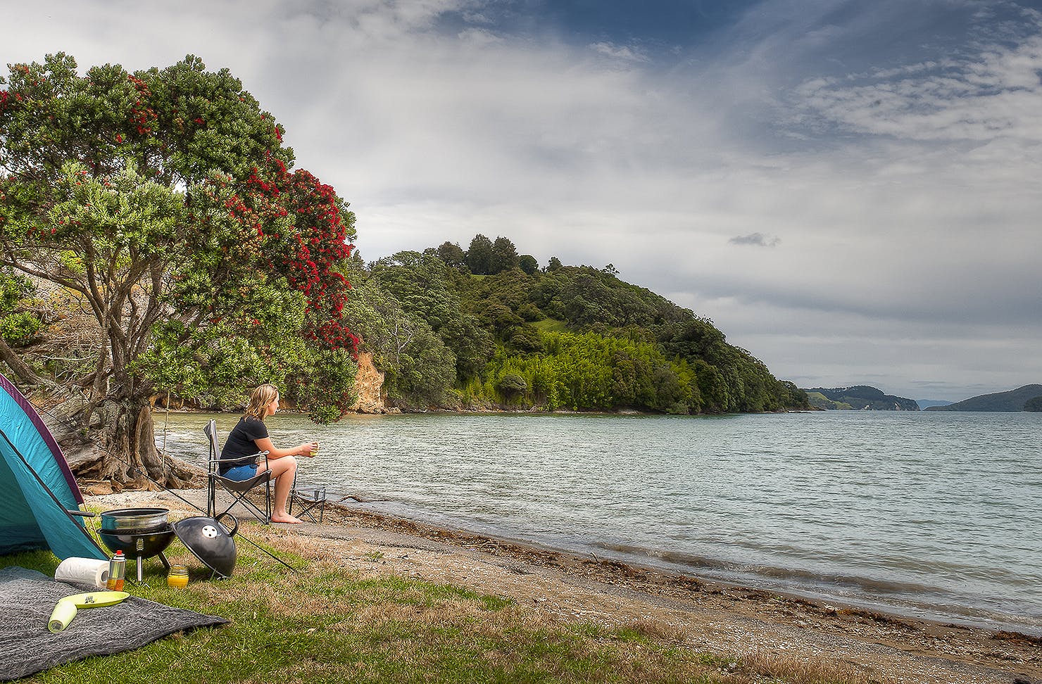 A person looks out at the water at Shelly Beach camp grounds.