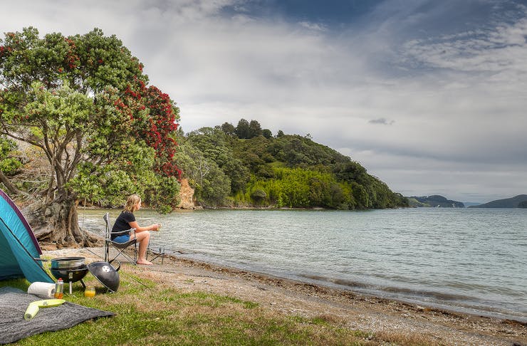 A person looks out at the water at Shelly Beach camp grounds.