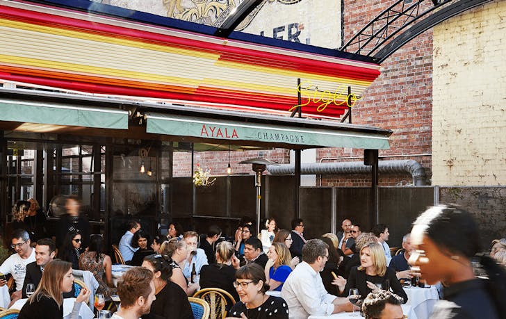 A rooftop bar with a colour sign, a top cocktail bar in Melbourne CBD.