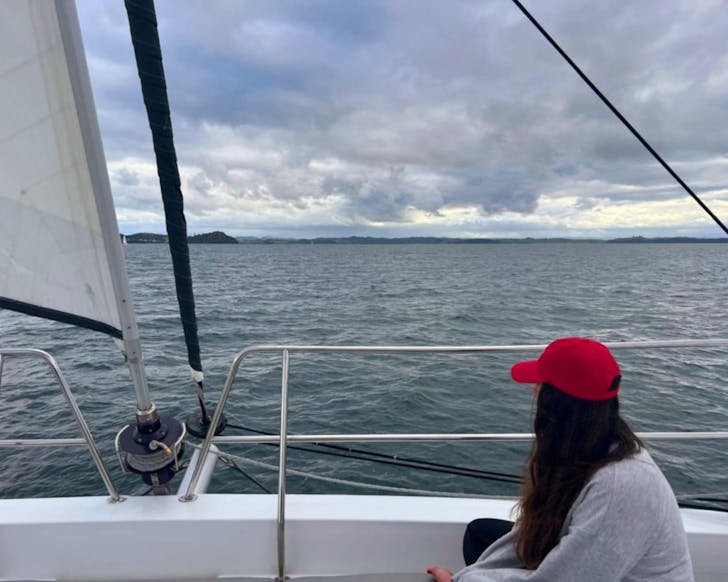 Kathryn sitting on the bow of Serenity, Silver Wave Yacht Charters' catamaran. 