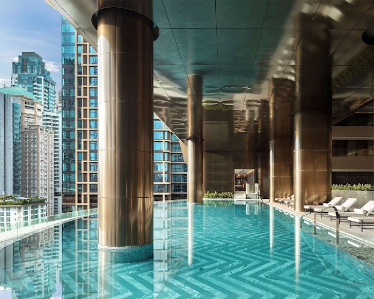 The pool with its gold columns at Sindhorn Kempinski one of the best Bangkok hotels