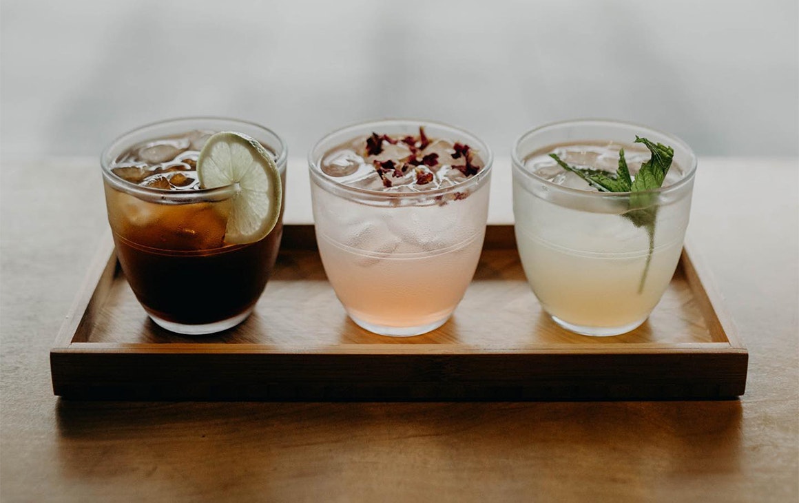 a row of three drinks on a window sill