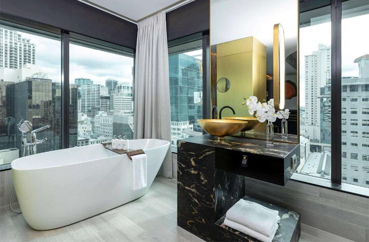 A lush window filled bathroom at So/ Auckland, one of the best hotels in Auckland.