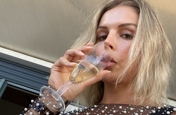 Person drinking sparkling wine