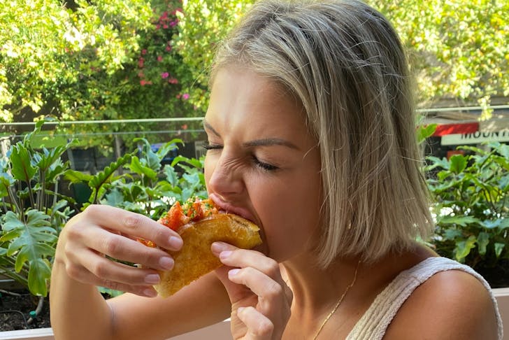 Woman eating taco
