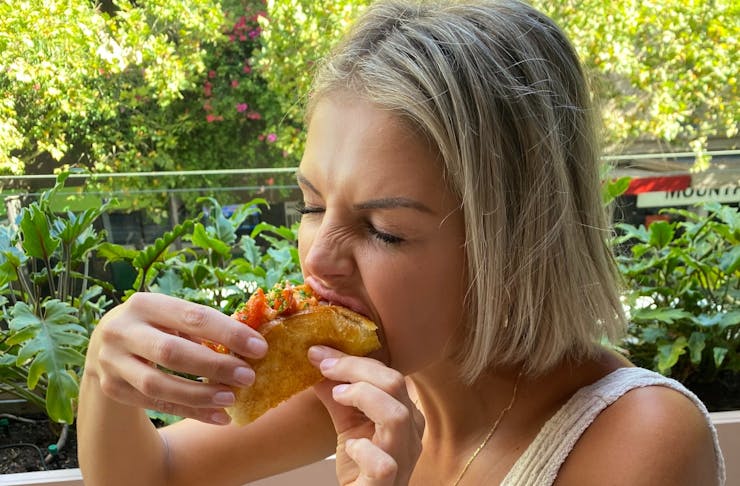 Woman eating taco