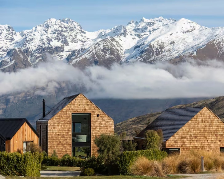 The stone property with mountains behind at Something Special one of the best Queenstown Airbnbs