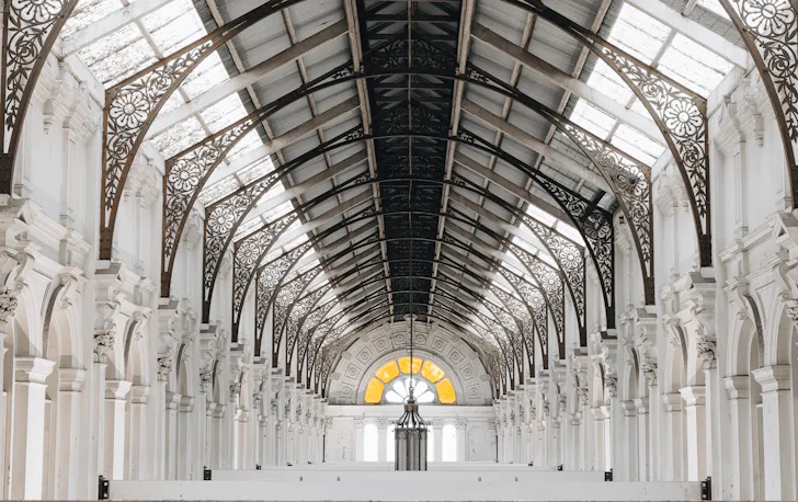 A big white hall with high ceilings. 
