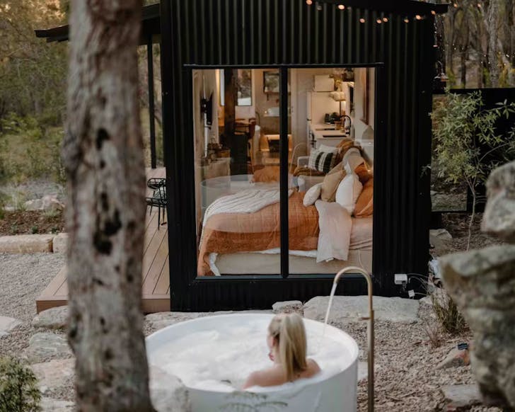 A view of the outdoor bath and the bedroom at Soulful Wildnerness Cabin South Maroota NSW