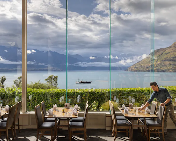 Wall-to-ceiling window view of Lake Wakatipu and the Remarkables.