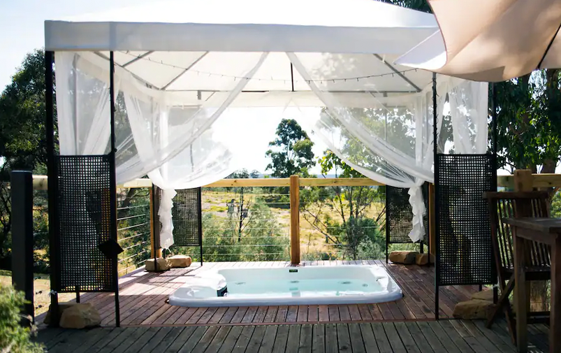 A spa on a deck overlooking a garden in Victoria. 
