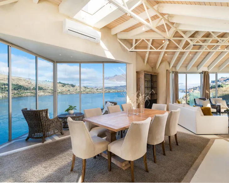 A view of the living space overlooking the lake at Spectacular Lakefront Home NZ