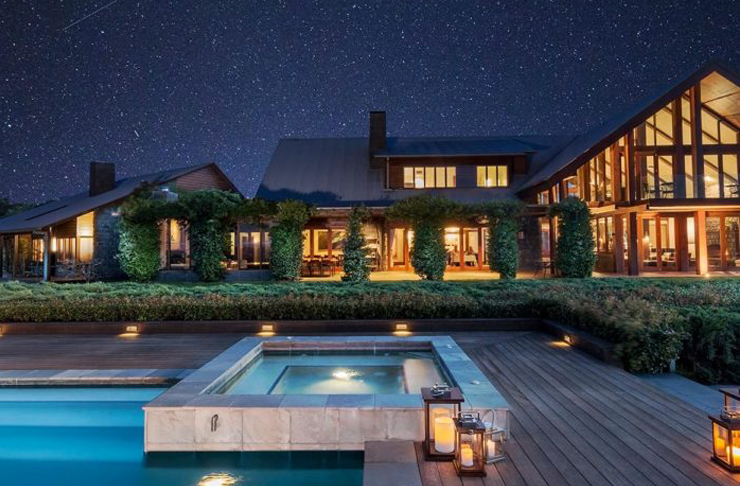 a hot tub in front of a building under a starry sky