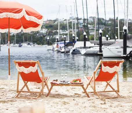 Beach umbrellas, oysters, chairs, and wine set up at St Siandra restaurant in Mosman. 