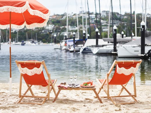 Beach umbrellas, oysters, chairs, and wine set up at St Siandra restaurant in Mosman. 
