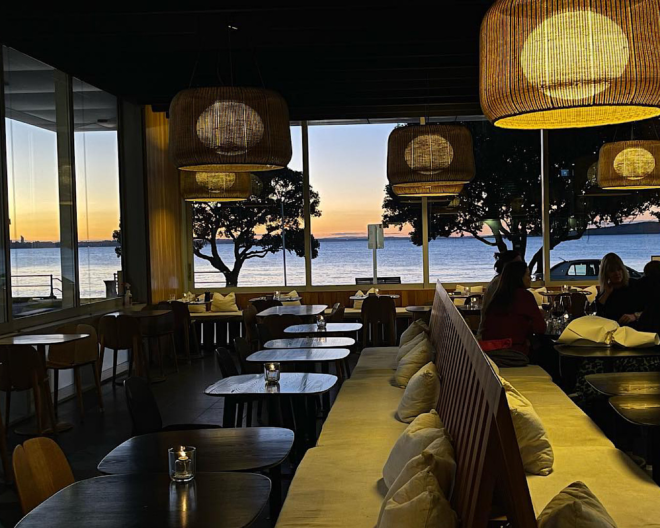 Set tables for sunset at St Heliers Bay Bistro, with a glorious, wraparound view of St Heliers beach and Rangitoto. 