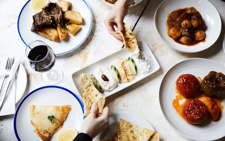 A table filled with dips, breads and meat at one of the best late-night restaurants in Melbourne.