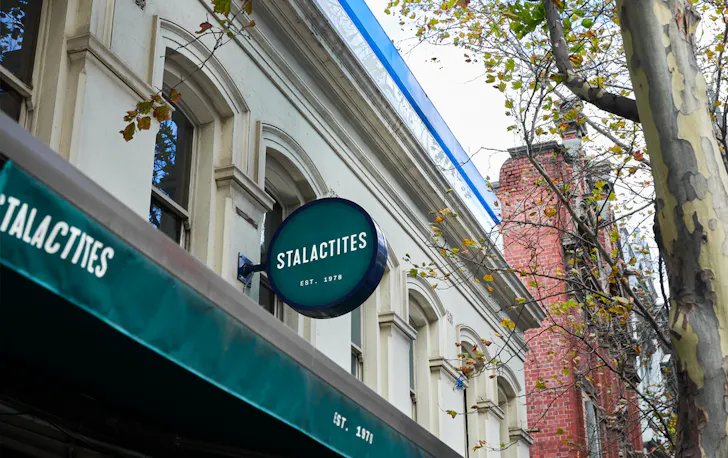 The outside of Stalactites with a green sign. 