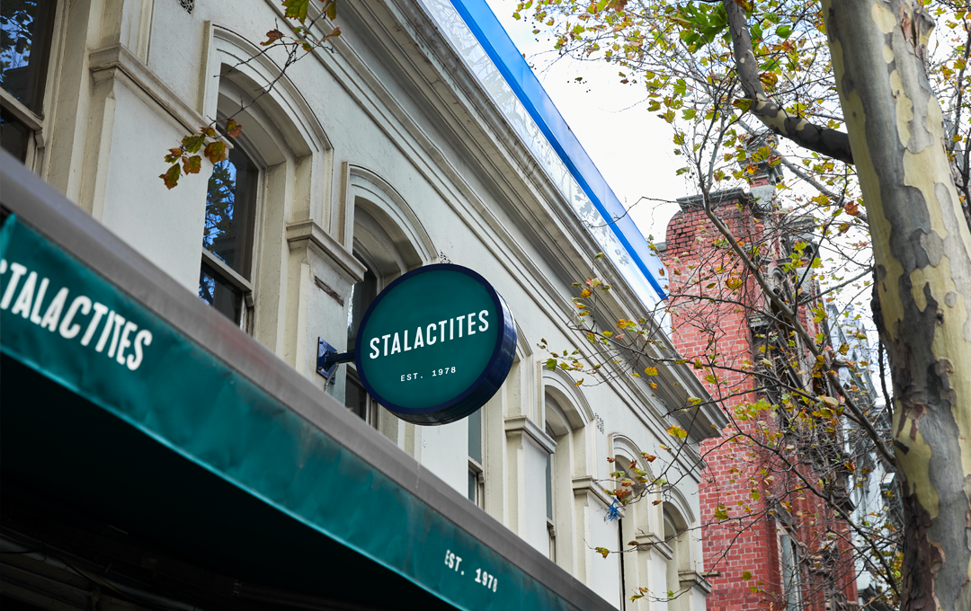 The outside of Stalactites with a green sign. 