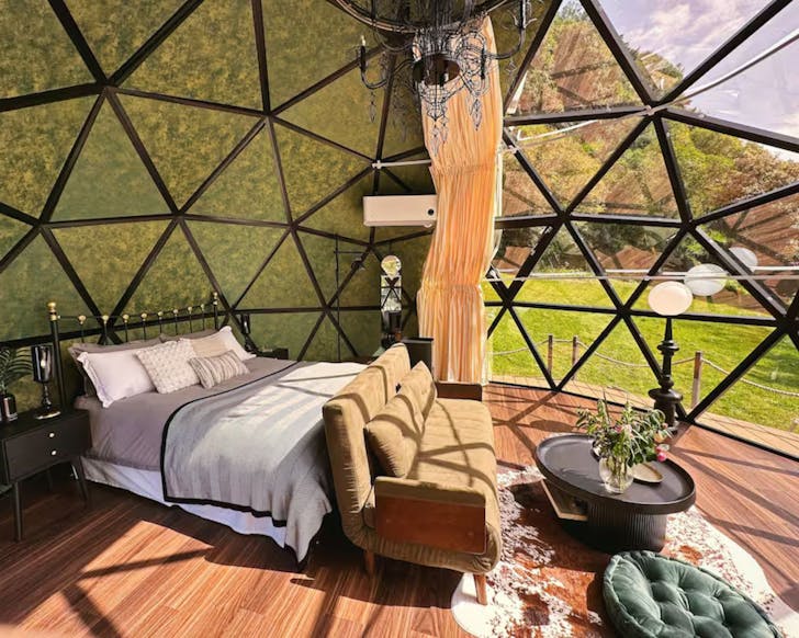 A view of the bedroom and the glass windows at the Amour Suite romantic Airbnb Auckland