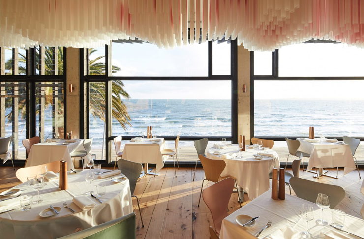 Light wooden floors, floor-to-ceiling windows and white table clothed tables at Stokehouse for Mothers Day in Melbourne