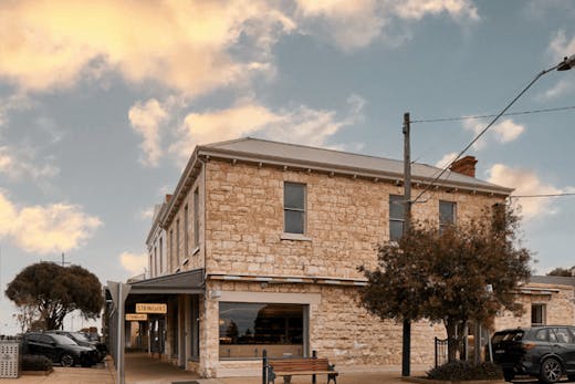 A large stone building on a corner.