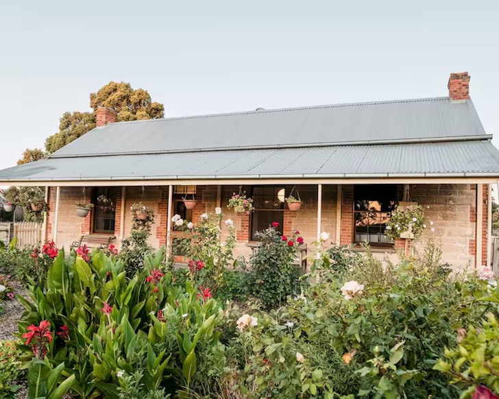 The exterior of Strout Farm Cottage one of the best Airbnbs near Adelaide, surrounded by garden