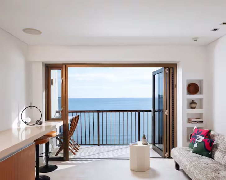 A view of the sea out of the window from the living space at Studio 1201 Airbnb one of the best Townsville stays
