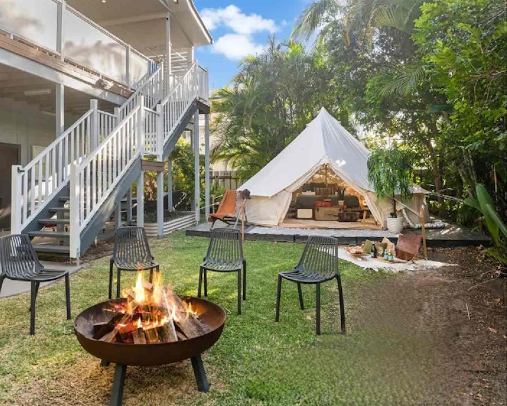 Backyard with glamping tent and fire pit