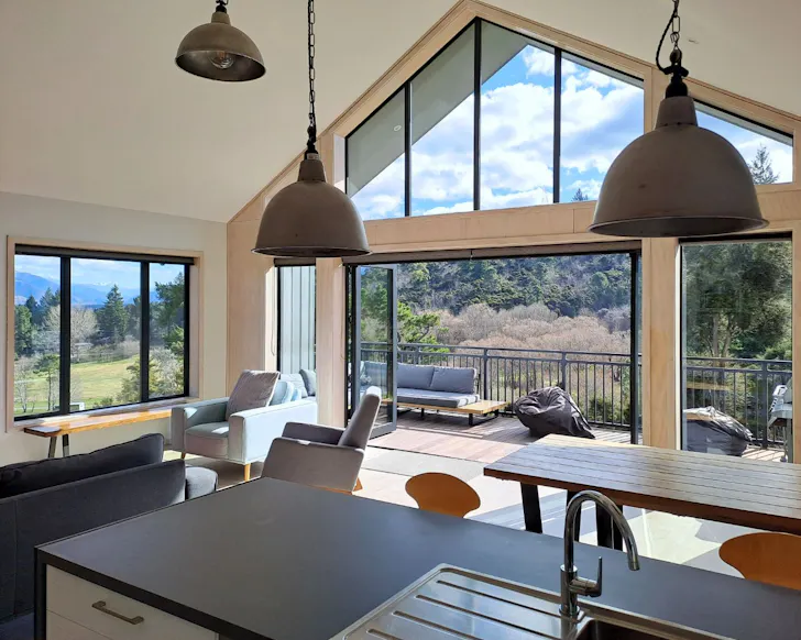 The living space and balcony at Stylish Home With Hot Tub best Hanmer Springs accommodation