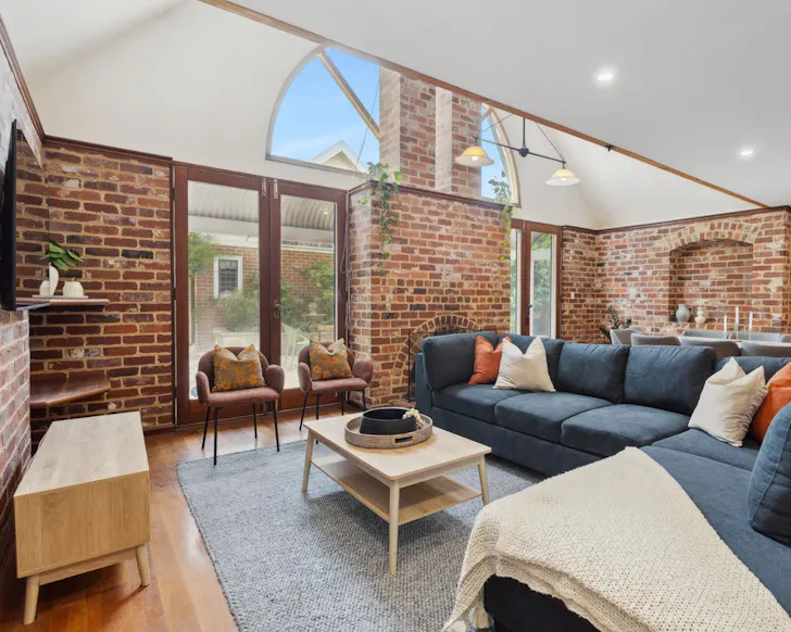 A view of the brick-walled living space at Subi Haus one of the best Perth Airbnbs