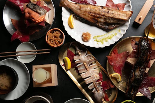 A table laden with all manner of Japanese dishes