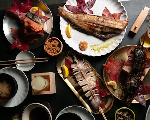 A table laden with all manner of Japanese dishes
