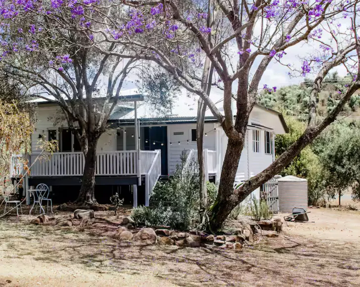 A vire of the white weatherboard exeterior at Summerholm House one of the best kid-friendly Airbnbs in Australia