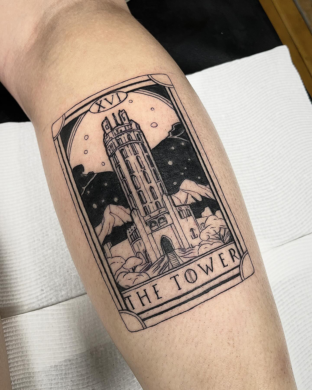 Someone with a tarot card tattoo from Sunset.