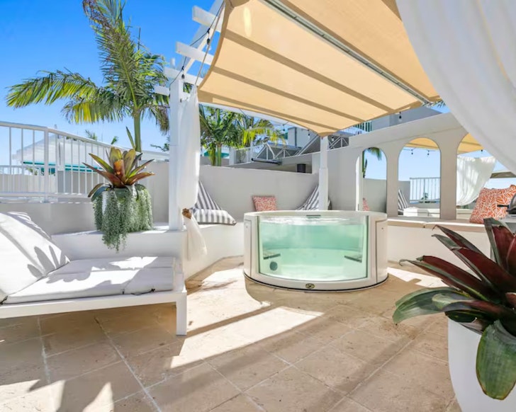 A view of the deck and hot tub at Sunset Haven Penthouse Suite one of the best Noosa Airbnbs