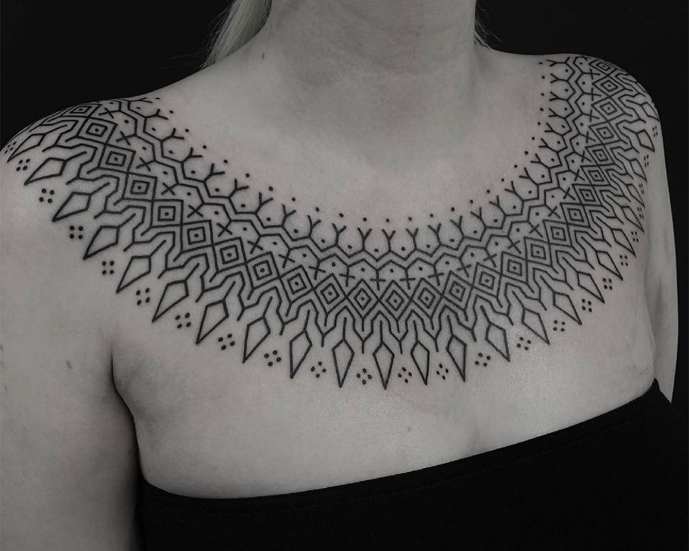 A black and white picture of a beautiful chest tattoo from Sunset Tattoo.