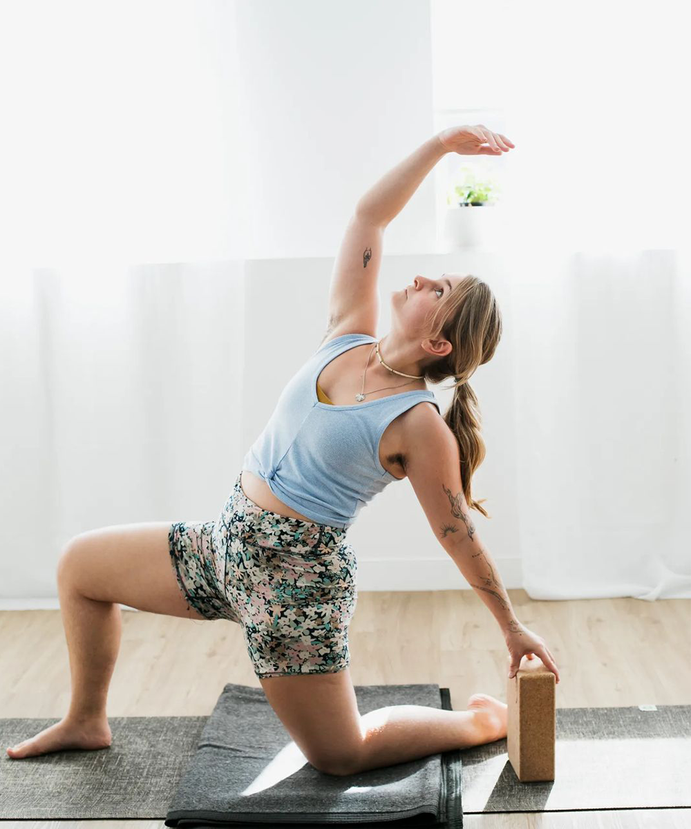 woman stretching on yoga block