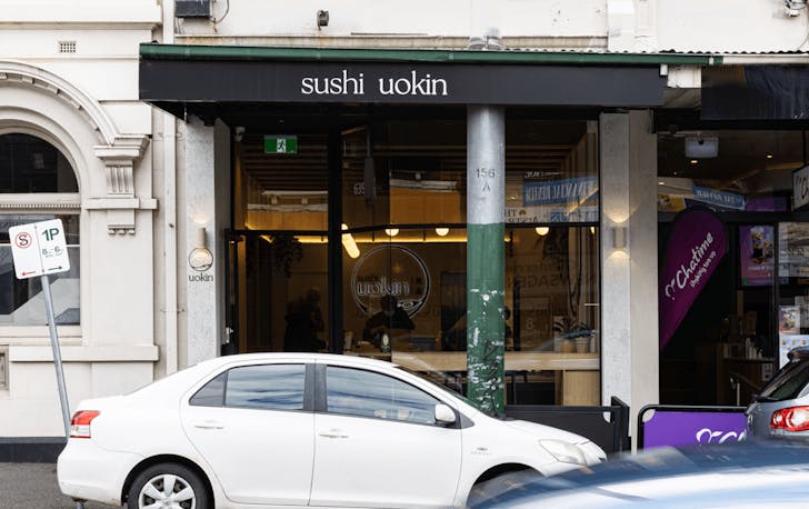 A shopfront with a black awning. 
