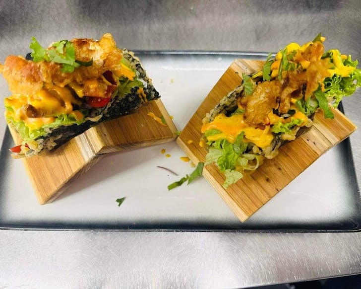A pair of sushi tacos are propped up in bamboo holders at Gohan On Scott, one of the best restaurants in Blenheim. 