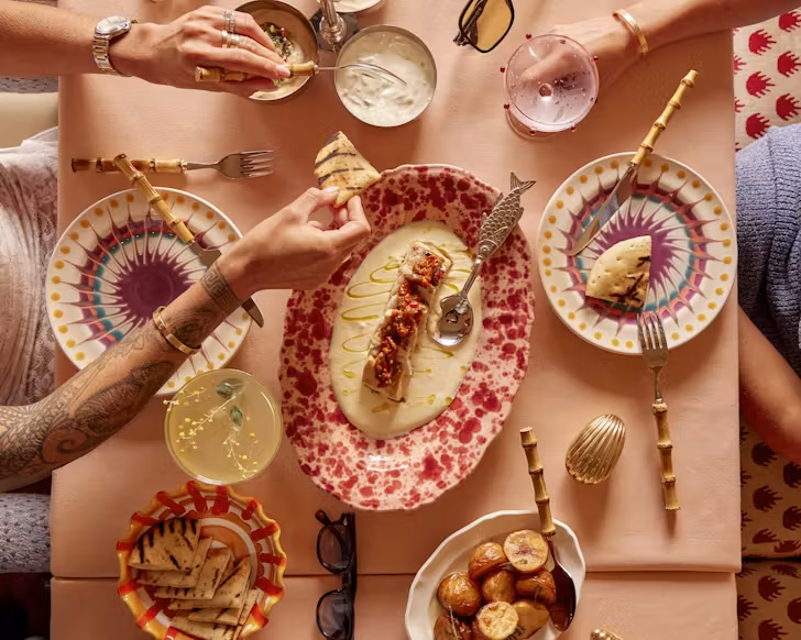 a spread of dishes including fish and dips at sydney greek restaurant akti