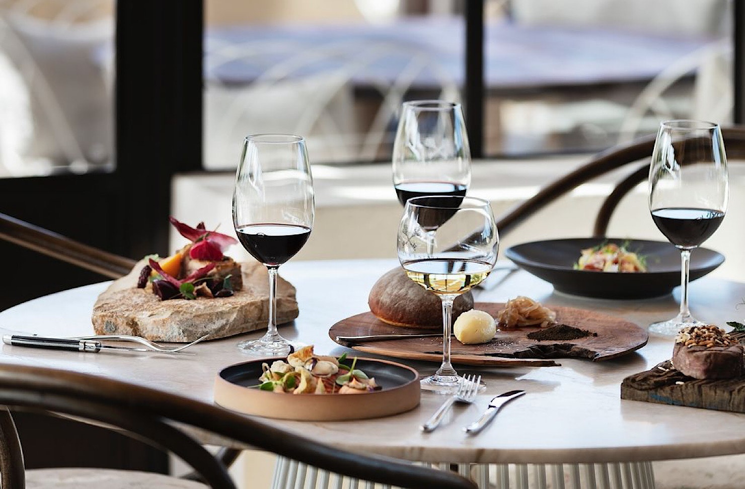 A beautifully set table at Tantalus with snacks and wine glasses, prepped for a wine tasting. 