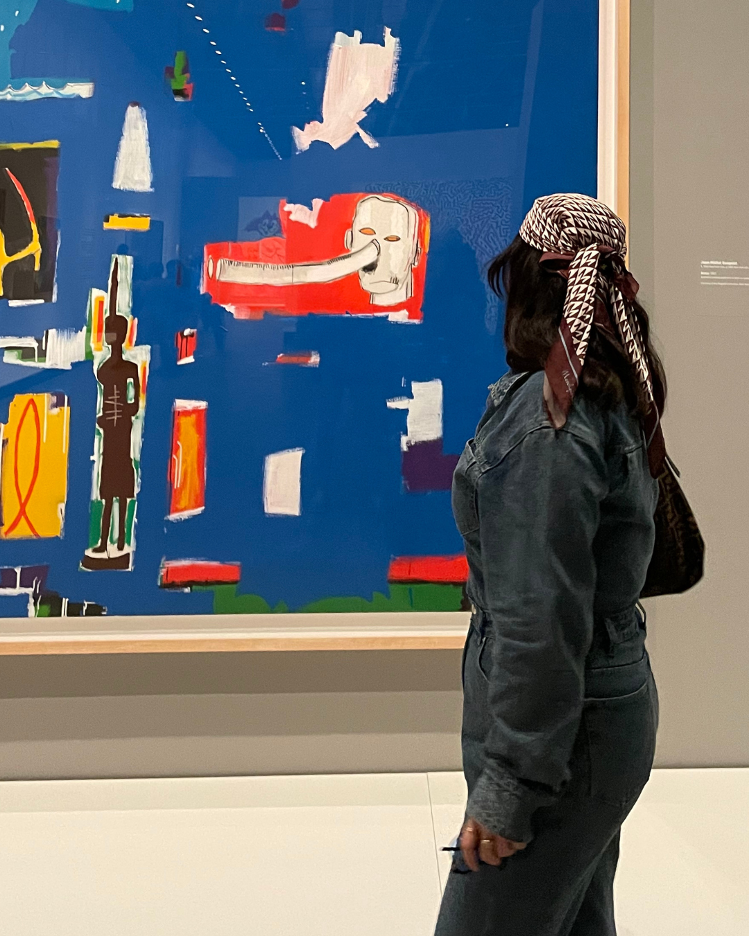 person standing in front of a painting